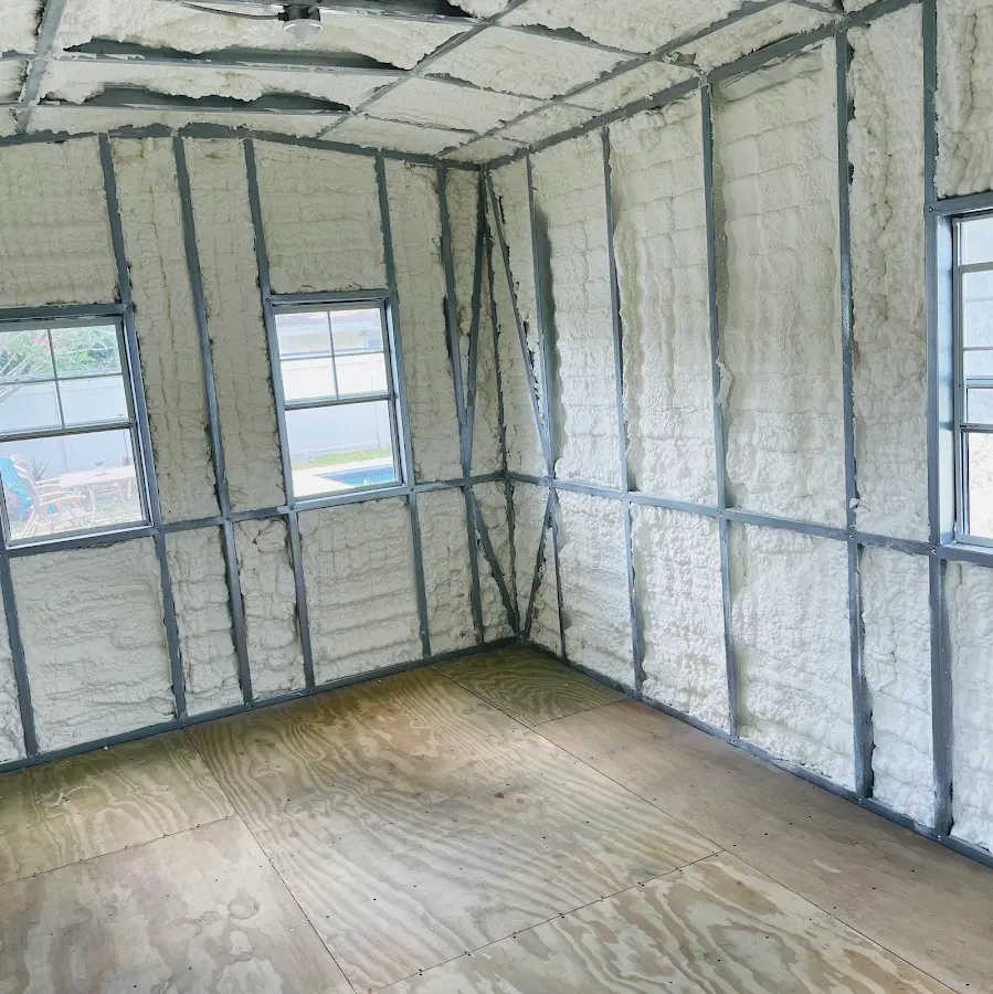 Closed-cell spray foam insulation applied to wall cavities in a residential project in Newton